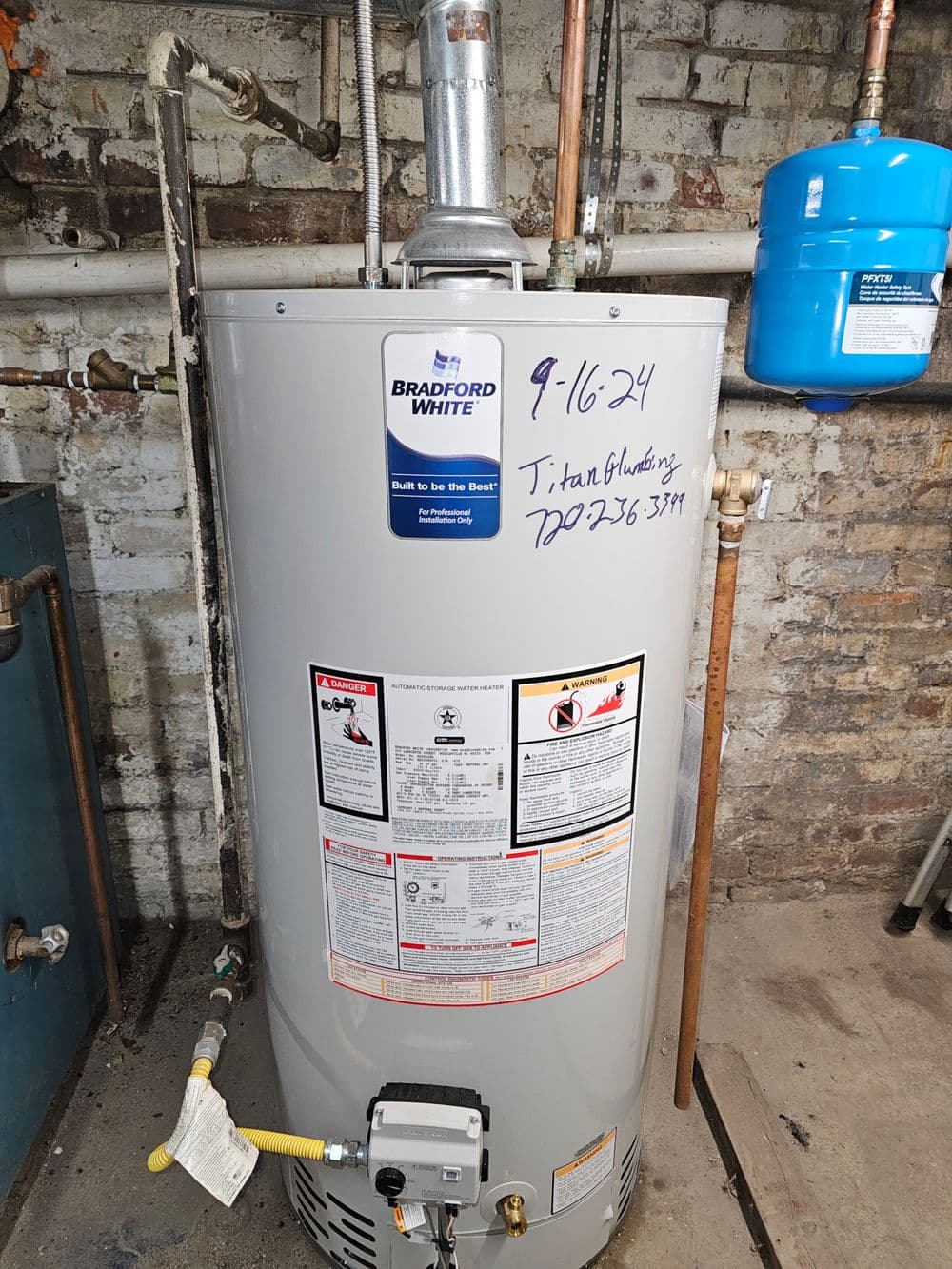 Bradford White water heater with installation date and contact details for service.